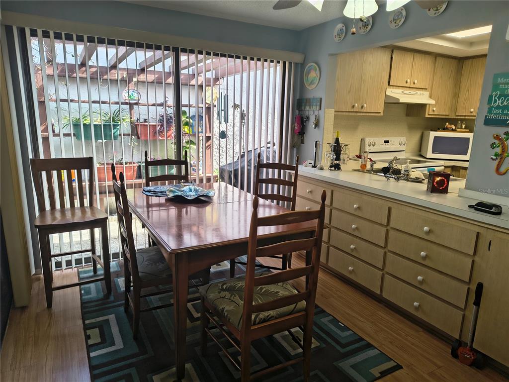 7519 Clanton Trail Hudson, FL 34667 - Photo 26 of 83 a kitchen with a table chairs stove and cabinets