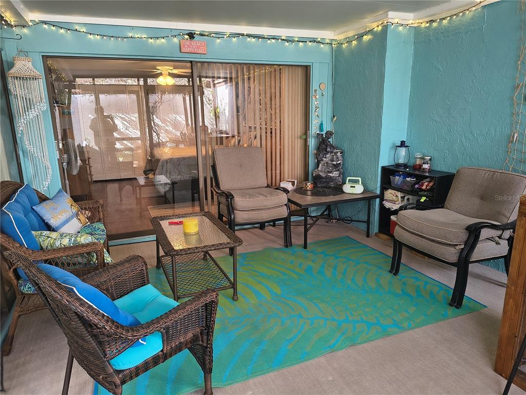 7519 Clanton Trail Hudson, FL 34667 - Photo 28 of 83 a living room with patio furniture and a floor to ceiling window