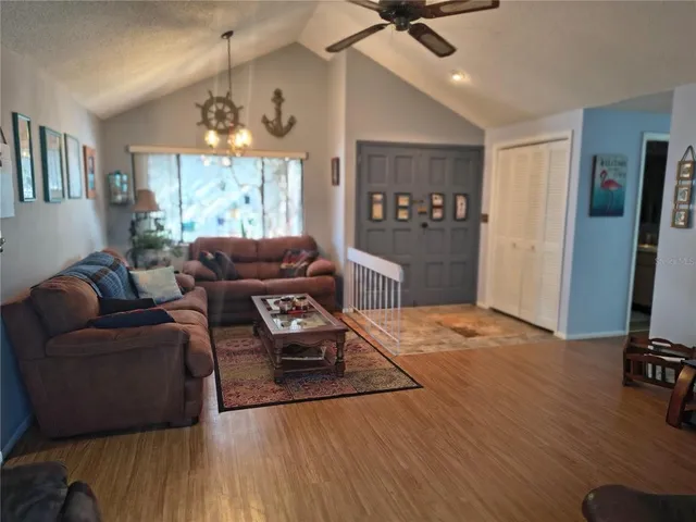 a living room with furniture window and wooden floor