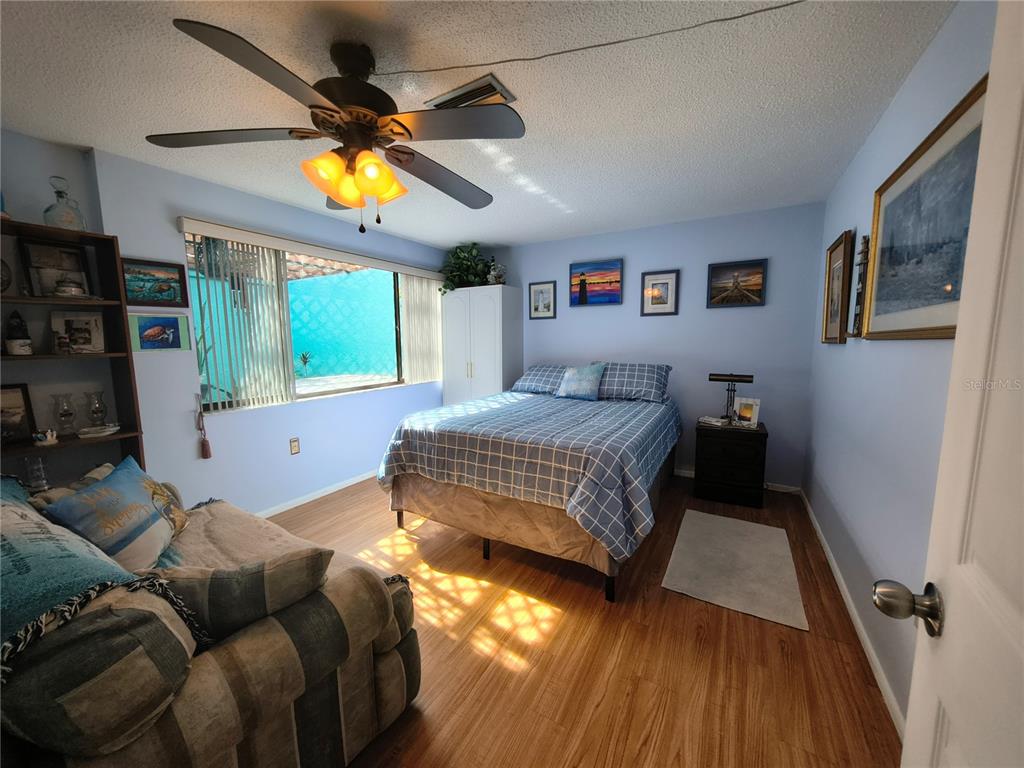 7519 Clanton Trail Hudson, FL 34667 - Photo 36 of 83 a bedroom with a bed and wooden floor