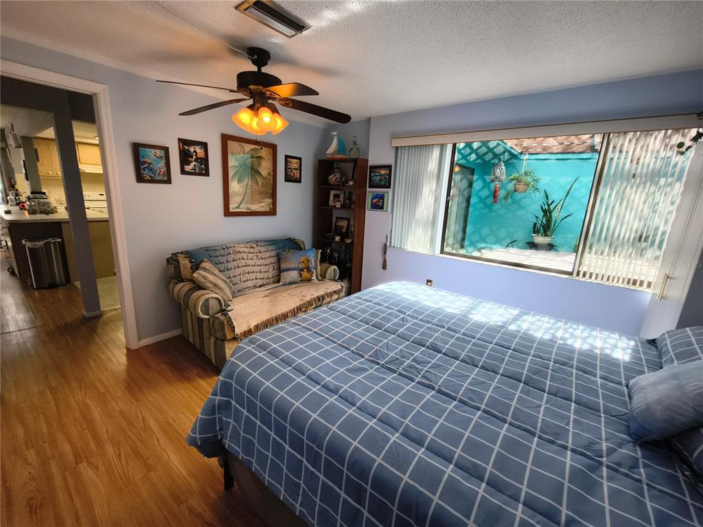 7519 Clanton Trail Hudson, FL 34667 - Photo 37 of 83 a bedroom with a bed and wooden floor