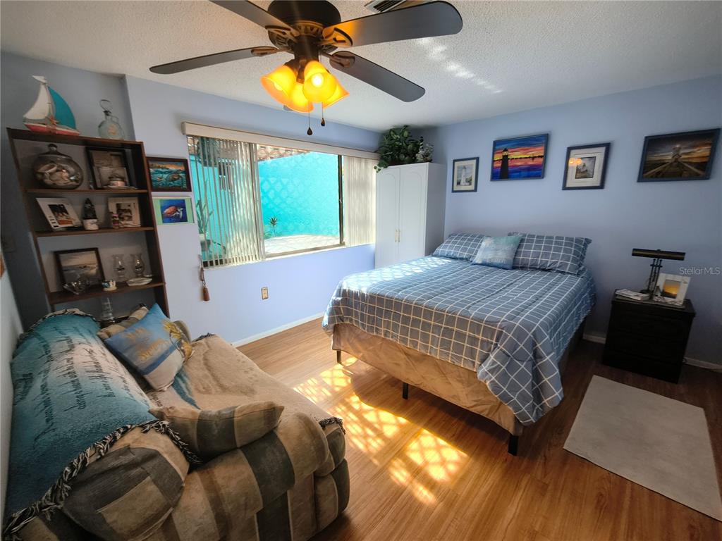 7519 Clanton Trail Hudson, FL 34667 - Photo 38 of 83 a bedroom with a bed and wooden floor