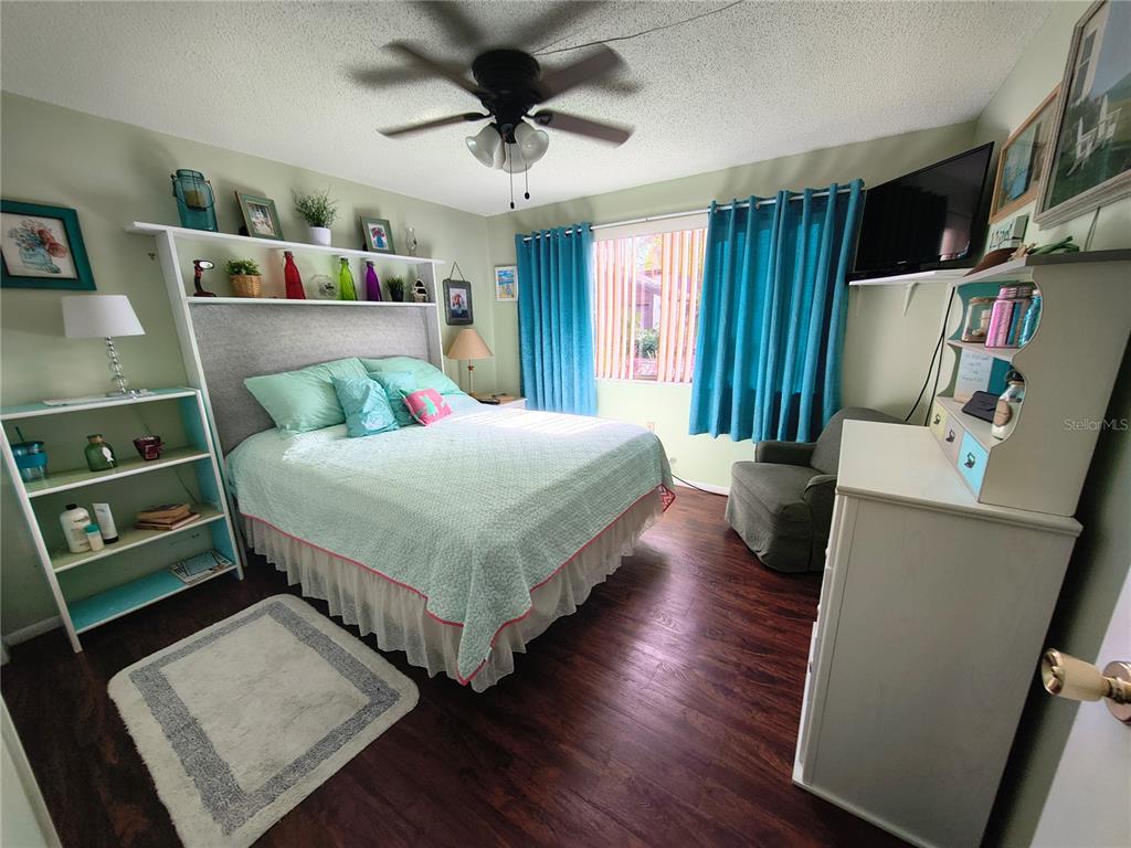 7519 Clanton Trail Hudson, FL 34667 - Photo 42 of 83 a bedroom with a bed a dresser and a book shelf
