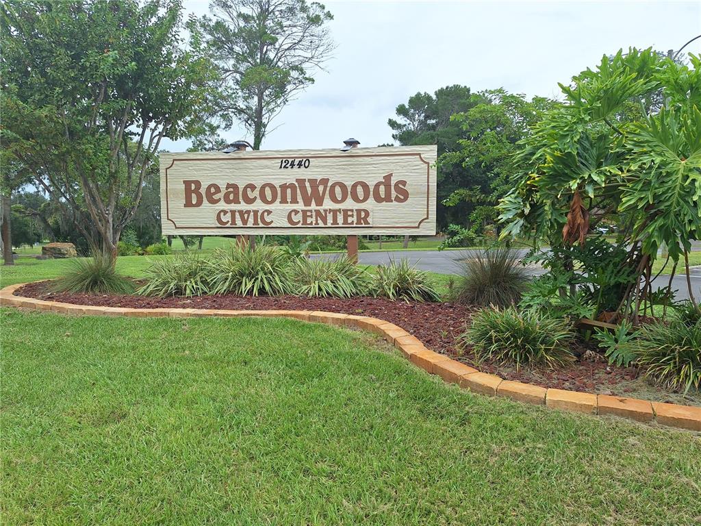 7519 Clanton Trail Hudson, FL 34667 - Photo 62 of 83 a sign of golf club on a wall under a tree