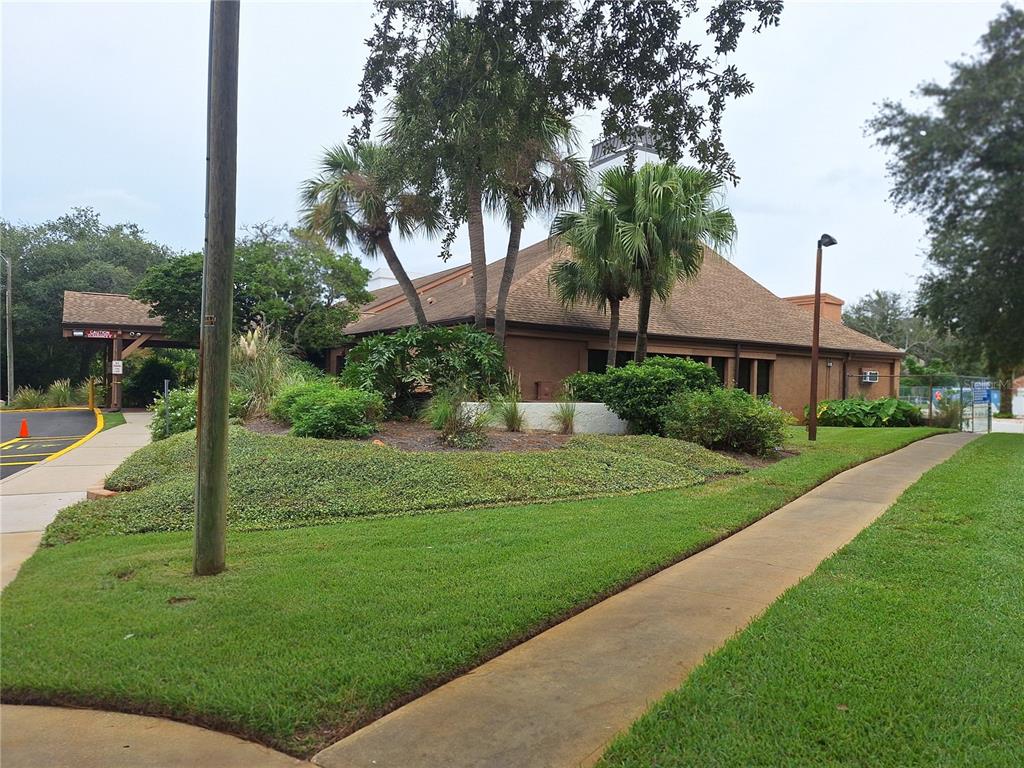 7519 Clanton Trail Hudson, FL 34667 - Photo 64 of 83 a view of a white house next to a yard with big trees