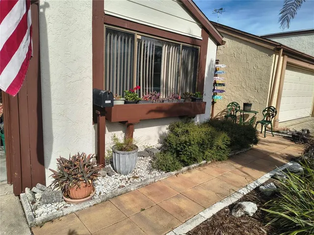 a house with potted plants in front of door