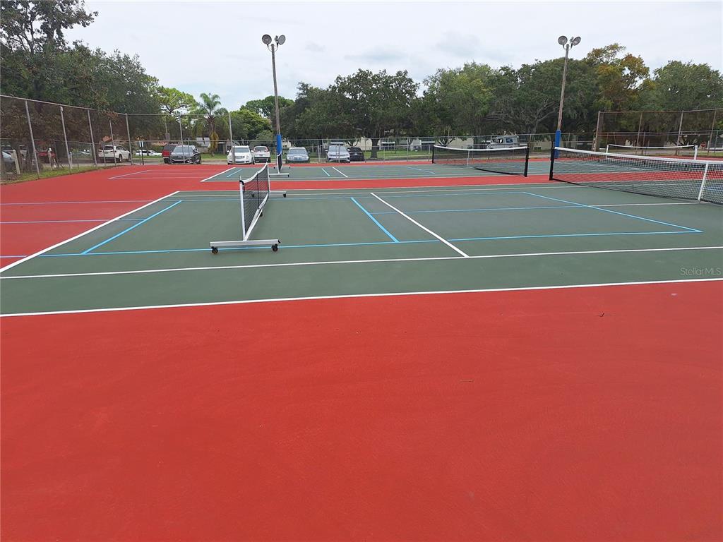 7519 Clanton Trail Hudson, FL 34667 - Photo 71 of 83 a tennis court that has tennis net