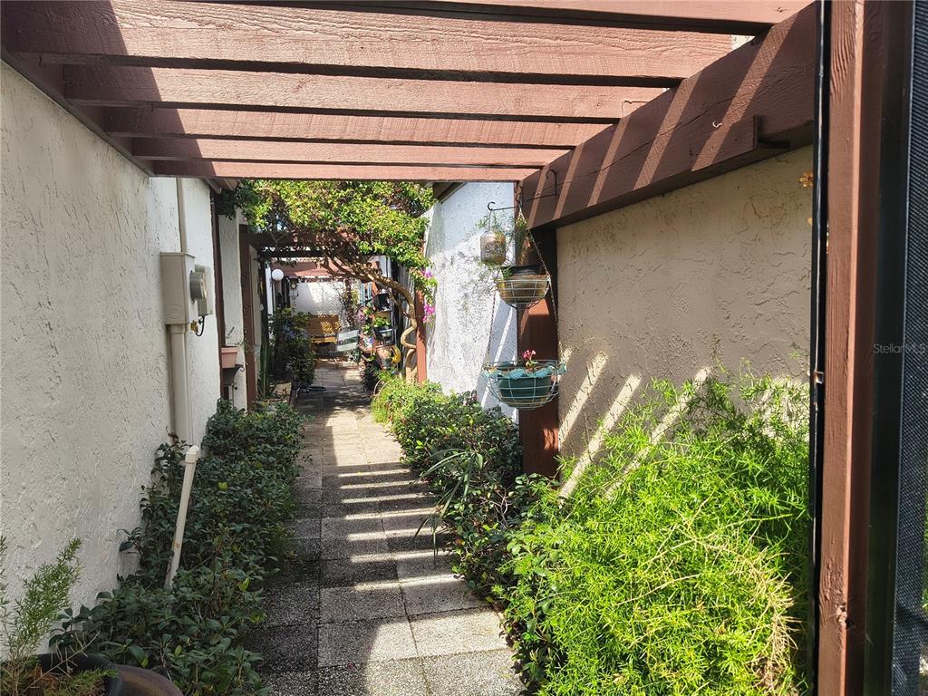 7519 Clanton Trail Hudson, FL 34667 - Photo 10 of 83 a house with potted plants in front of door