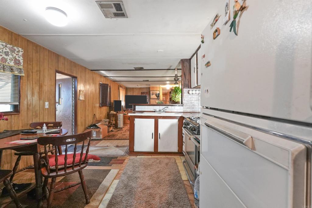 40645 Sage Road Hemet, CA 92544 - Photo 18 of 70 a kitchen with stainless steel appliances granite countertop a stove and a refrigerator