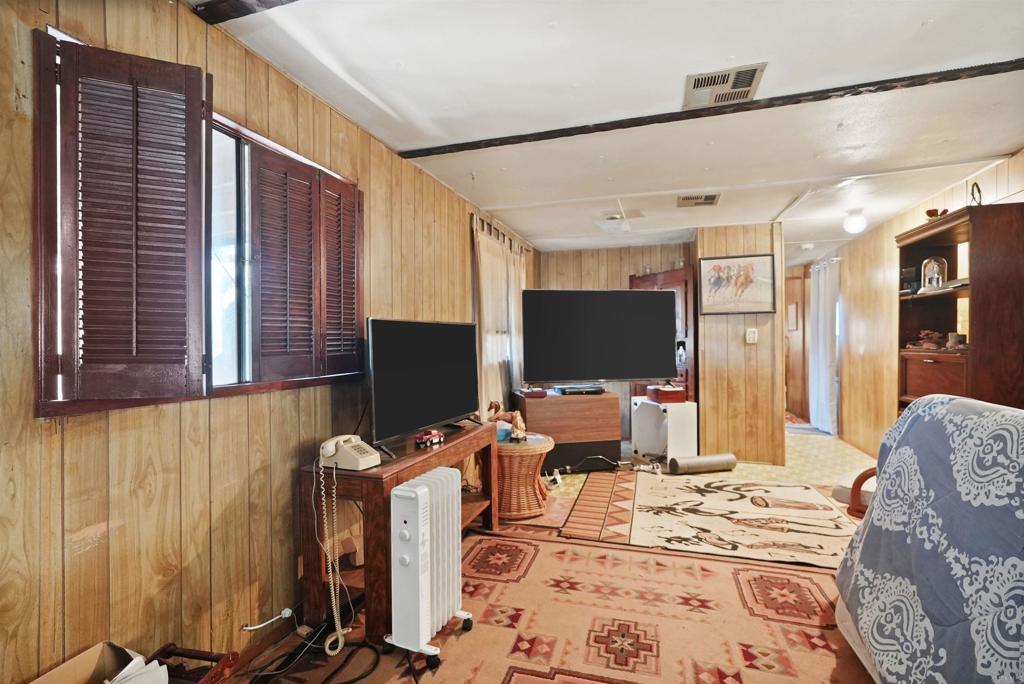 40645 Sage Road Hemet, CA 92544 - Photo 6 of 70 a bedroom with furniture and a flat screen tv