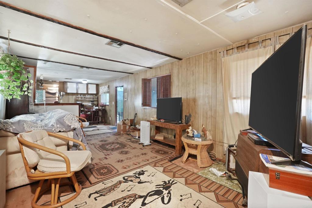 40645 Sage Road Hemet, CA 92544 - Photo 8 of 70 a living room with furniture a flat screen tv and a refrigerator