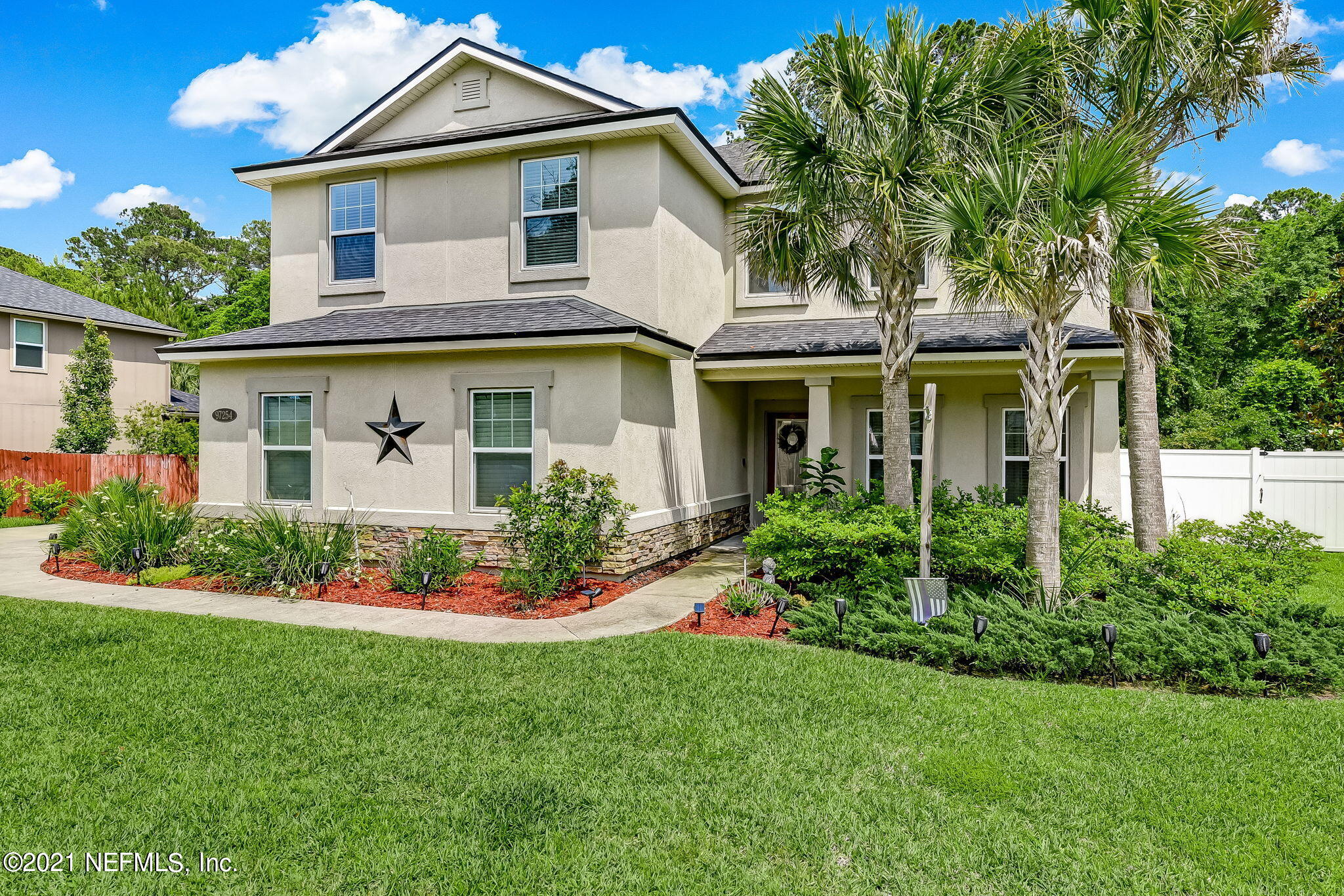 a front view of a house with a garden