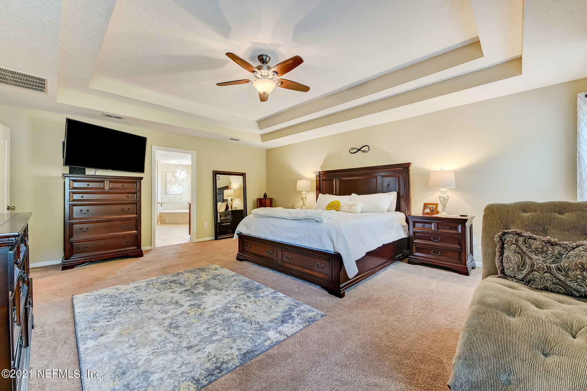 97254 Bluff View Circle Yulee, FL 32097 - Photo 15 of 34 a bedroom with a large bed and a flat screen tv