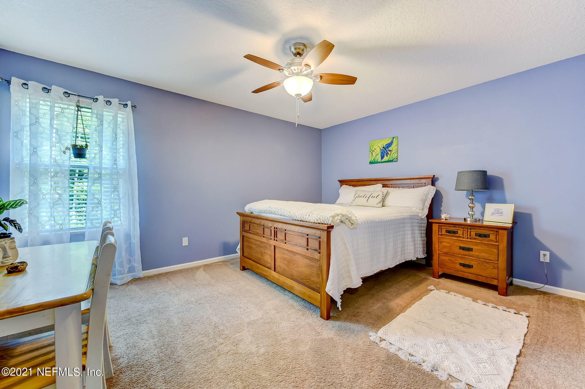97254 Bluff View Circle Yulee, FL 32097 - Photo 19 of 34 a bed room with a bed and a ceiling fan