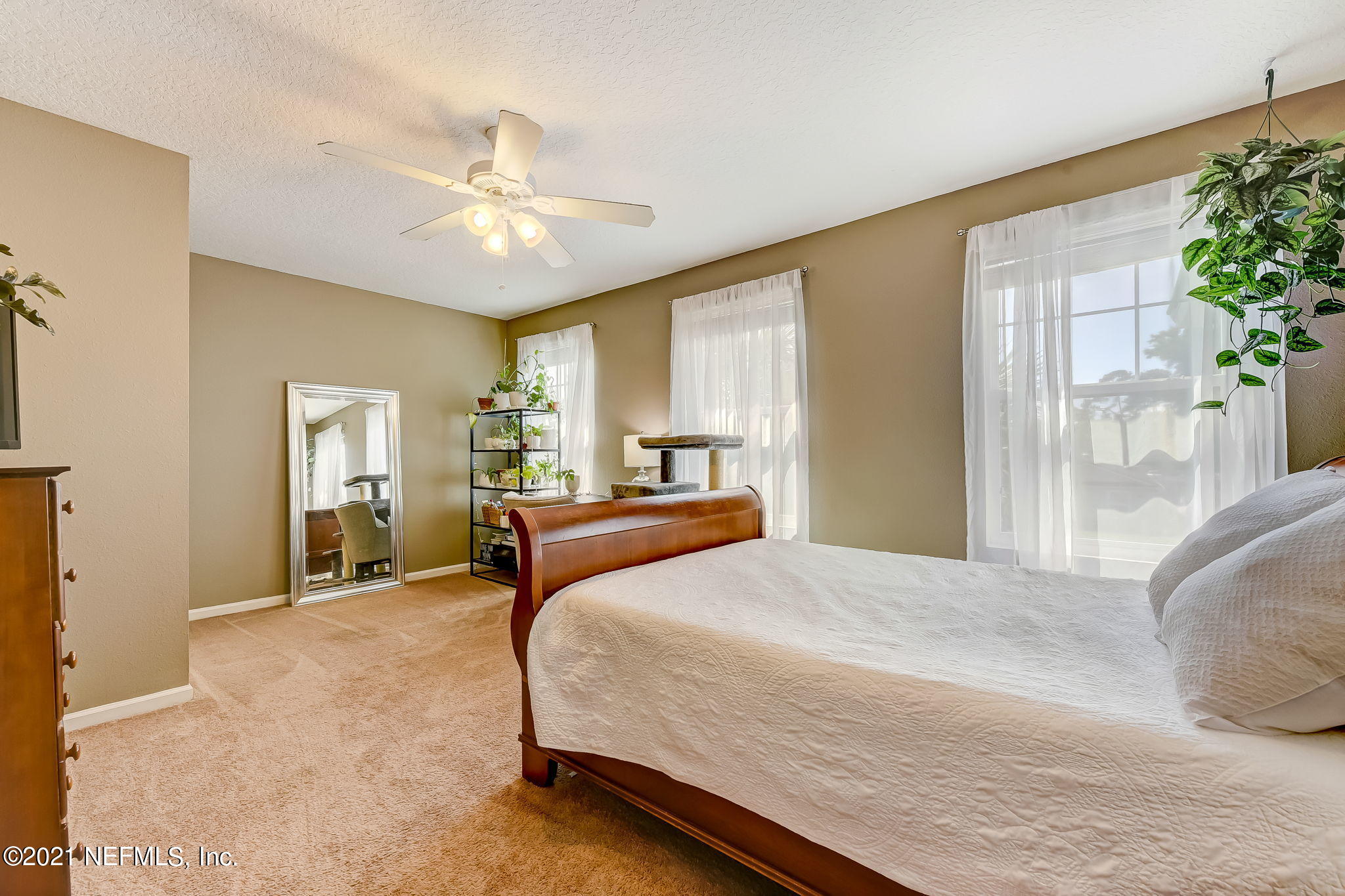 97254 Bluff View Circle Yulee, FL 32097 - Photo 22 of 34 a bedroom with a large bed and a chandelier