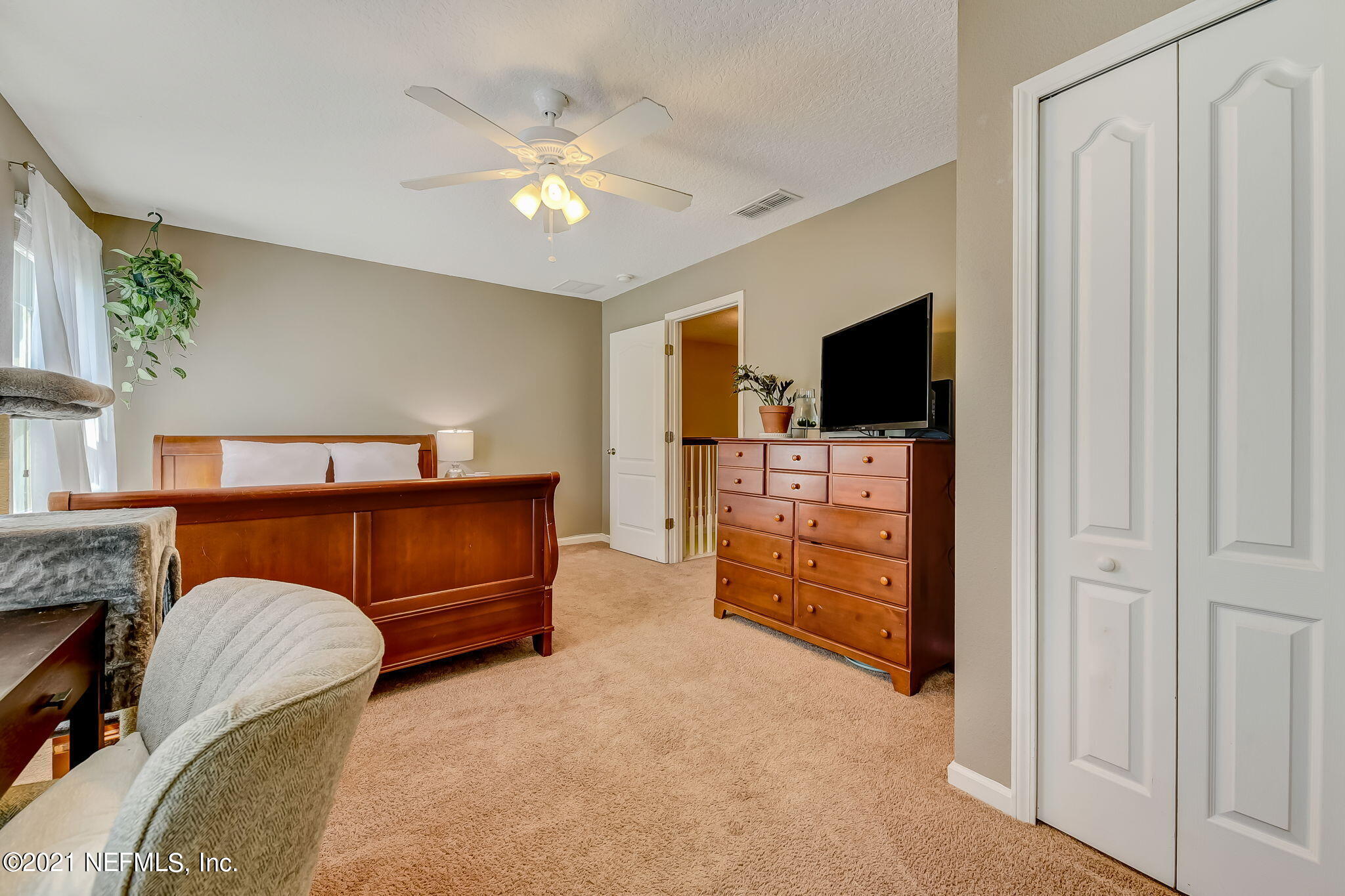 97254 Bluff View Circle Yulee, FL 32097 - Photo 23 of 34 a bed room with furniture and a flat screen tv