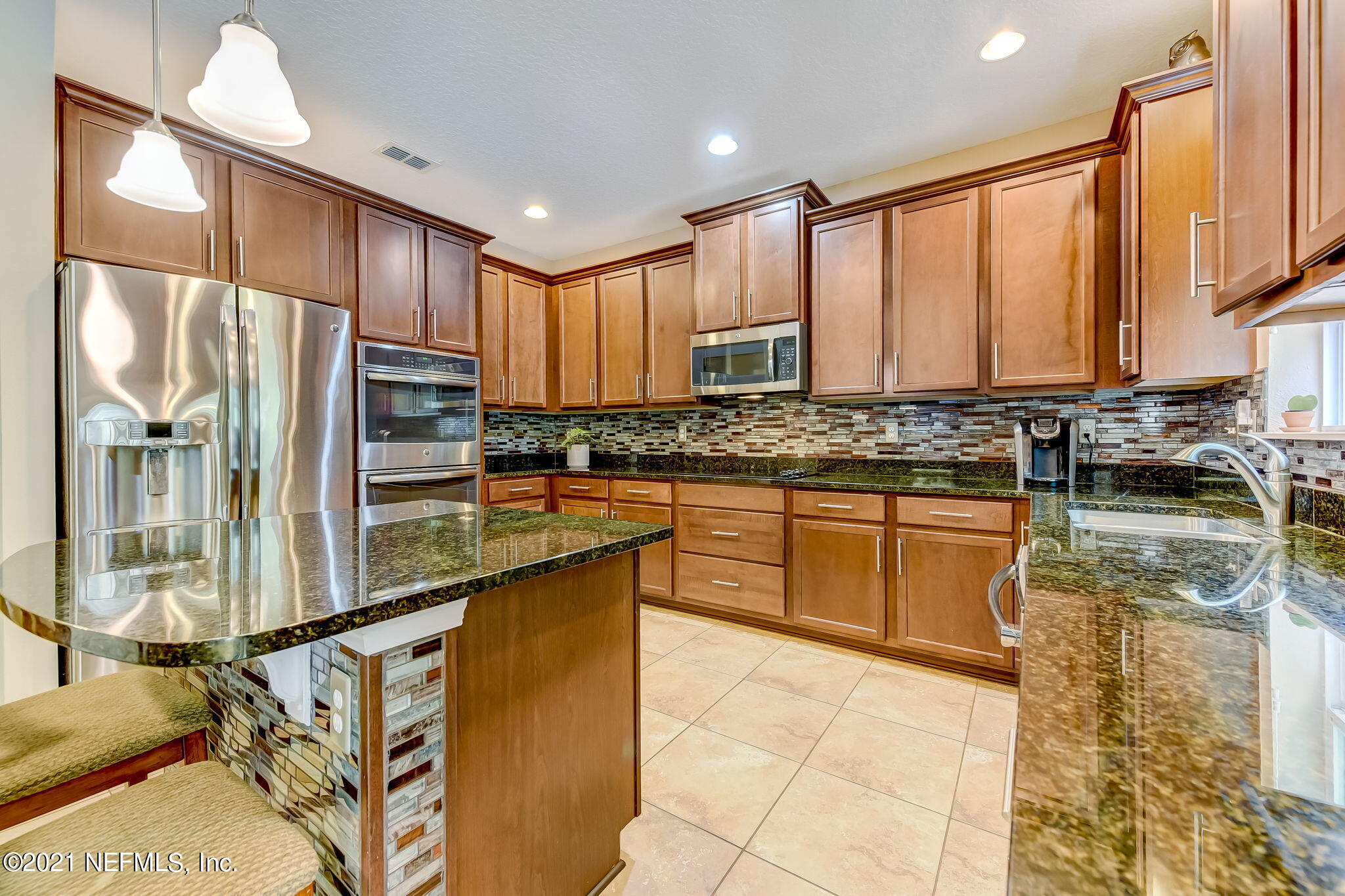 97254 Bluff View Circle Yulee, FL 32097 - Photo 6 of 34 a kitchen with stainless steel appliances granite countertop a stove a sink and a refrigerator