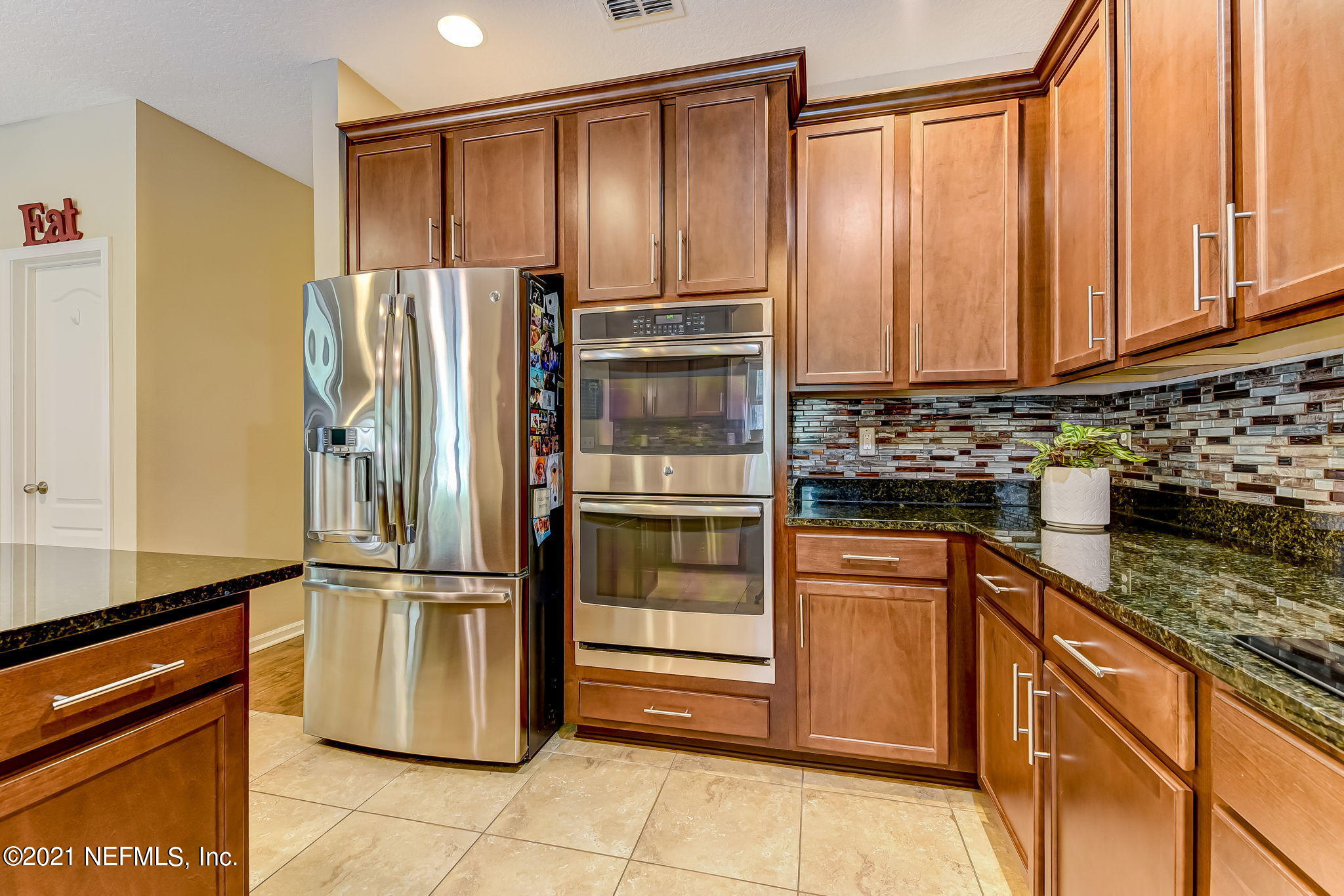 97254 Bluff View Circle Yulee, FL 32097 - Photo 7 of 34 a kitchen with a refrigerator and cabinets