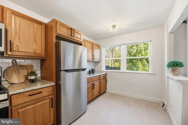a kitchen with stainless steel appliances granite countertop a refrigerator sink and stove