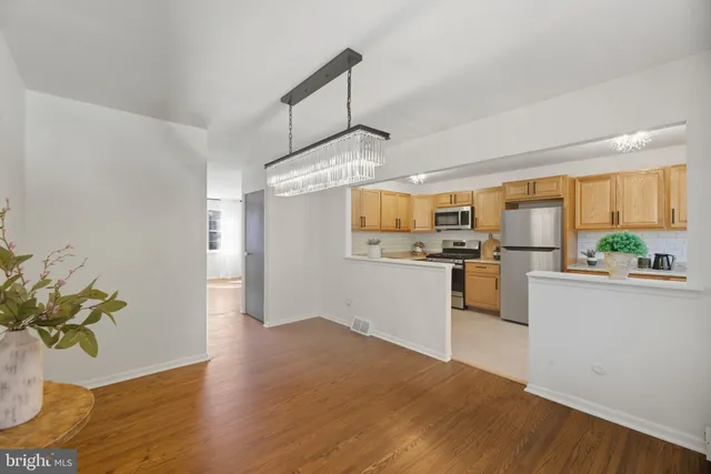 a kitchen with granite countertop white cabinets and refrigerator