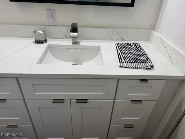 a bathroom with a sink toilet and mirror