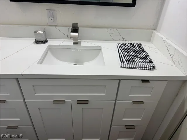 a bathroom with a sink toilet and mirror