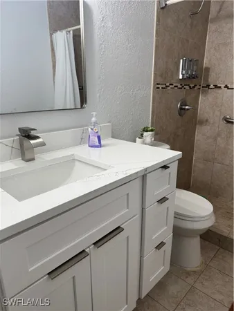 a white toilet and shower in a bathroom