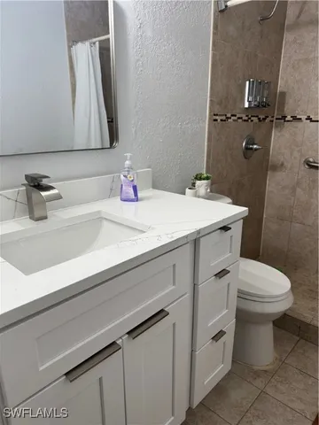 a white toilet and shower in a bathroom