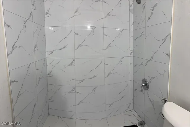 a kitchen with a checkered floor and white cabinets