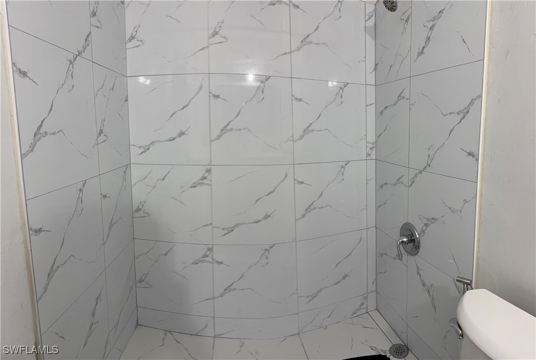 806 West 80th Place Hialeah, FL 33014 - Photo 14 of 17 a bathroom with a toilet and a shower