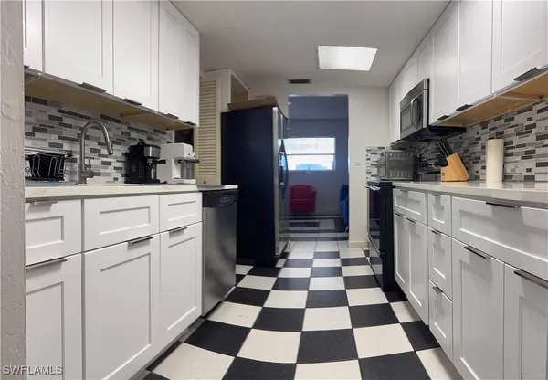 a kitchen with a stove a microwave and cabinets