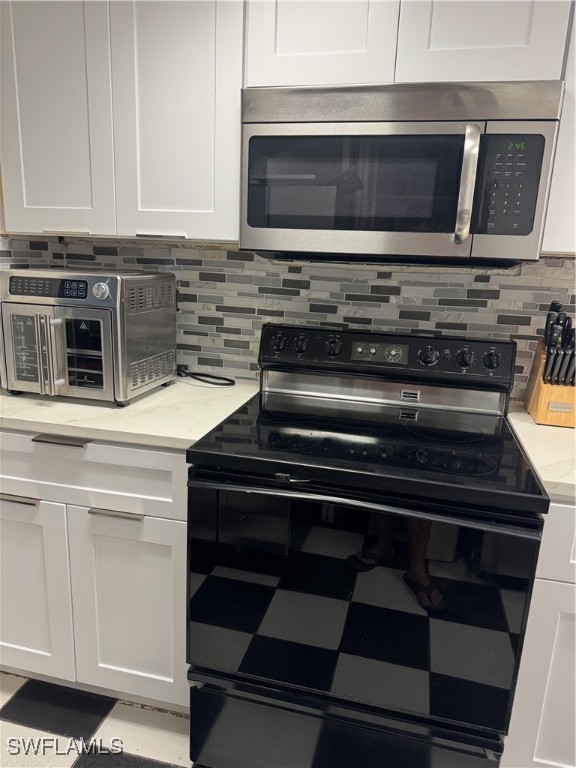 806 West 80th Place Hialeah, FL 33014 - Photo 17 of 17 a stove top oven sitting inside of a kitchen