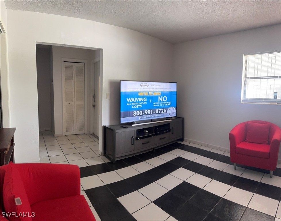 806 West 80th Place Hialeah, FL 33014 - Photo 4 of 17 a living room with a couch and a flat screen tv