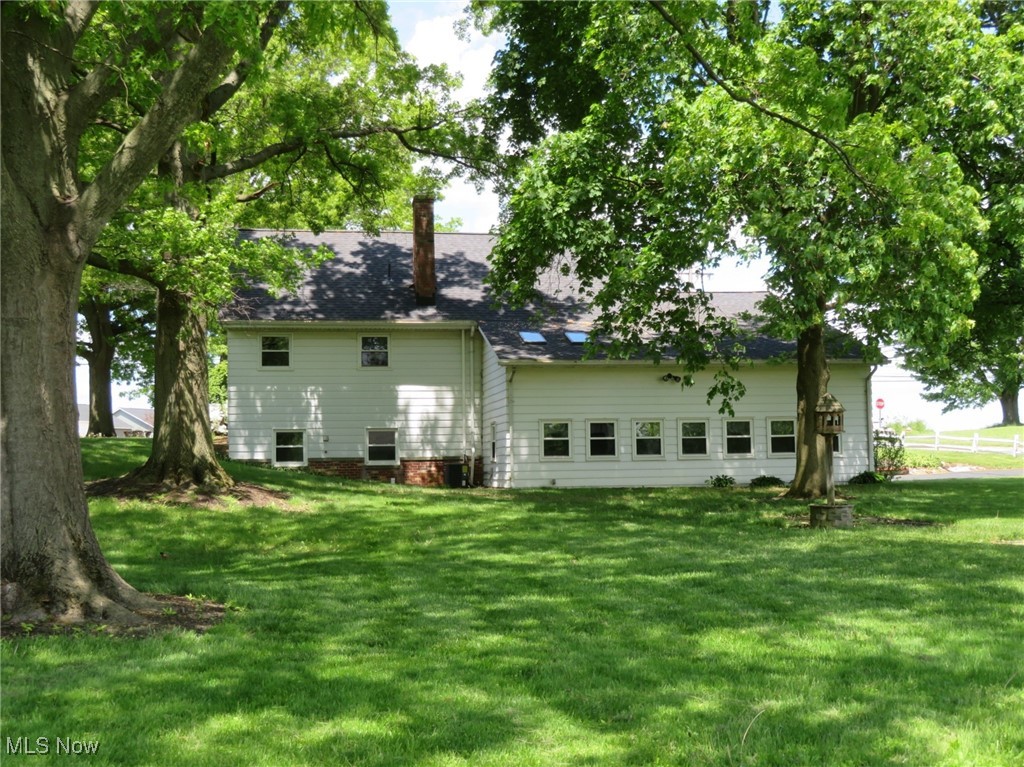 38505 Sugar Ridge Road North Ridgeville, OH 44039 - Photo 3 of 44 Rear view of this spacious home. The roof was replaced in 2024, as were the 2 skylights in the Sunroom. The entire home, sunroom & outbuilding has had newer windows installed throughout, between 2015-2022