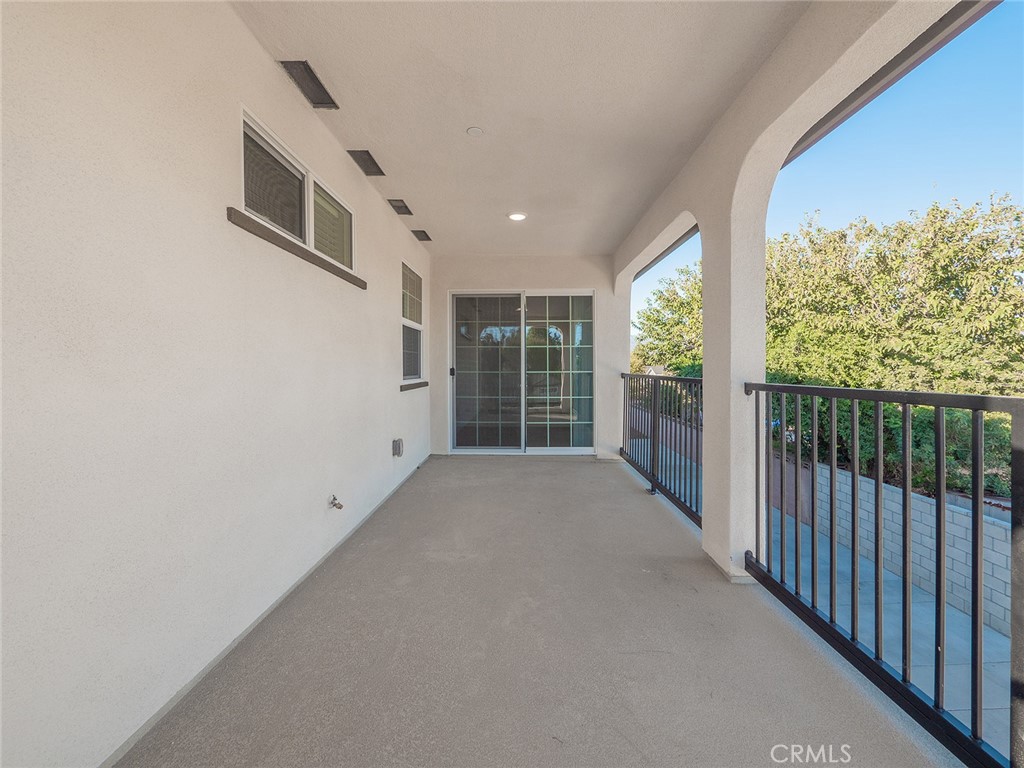 1325 West Grand Avenue, Unit 3 Pomona, CA 91766 - Photo 23 of 30 a view of a porch with wooden floor and fence