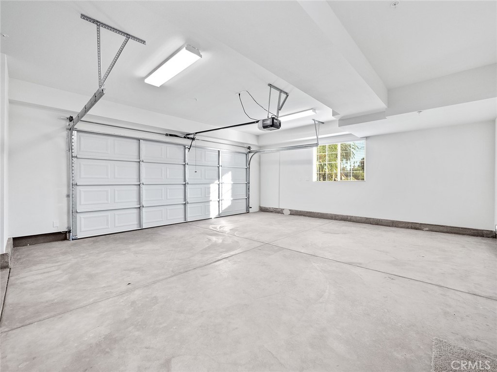 1325 West Grand Avenue, Unit 3 Pomona, CA 91766 - Photo 24 of 30 an empty room with windows and ceiling fan