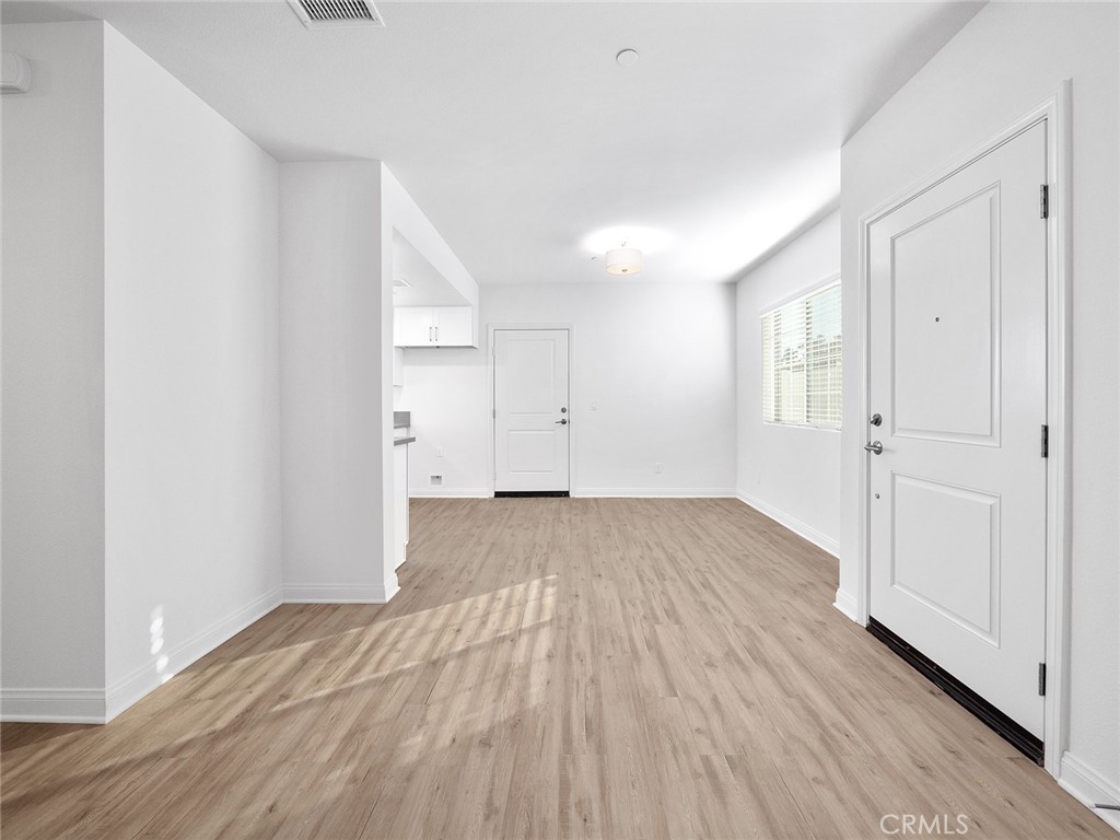 1325 West Grand Avenue, Unit 3 Pomona, CA 91766 - Photo 7 of 30 wooden floor in an empty room