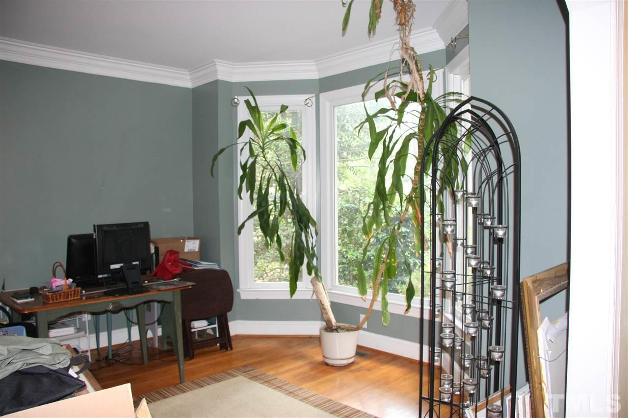 232 Release Circle Raleigh, NC 27615 - Photo 3 of 23 a workspace with furniture and a potted plant