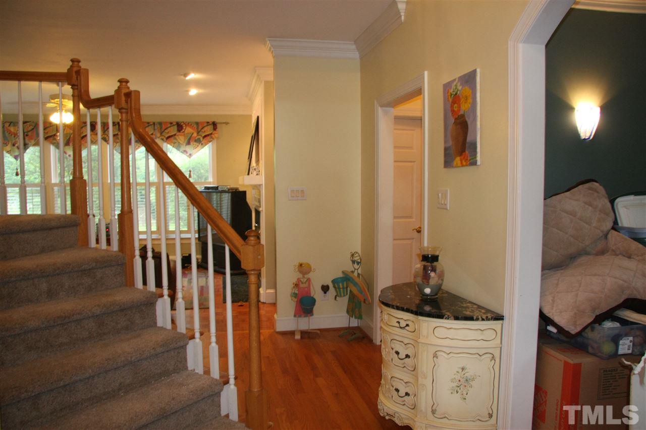 232 Release Circle Raleigh, NC 27615 - Photo 4 of 23 a hall way with wooden floor and furniture