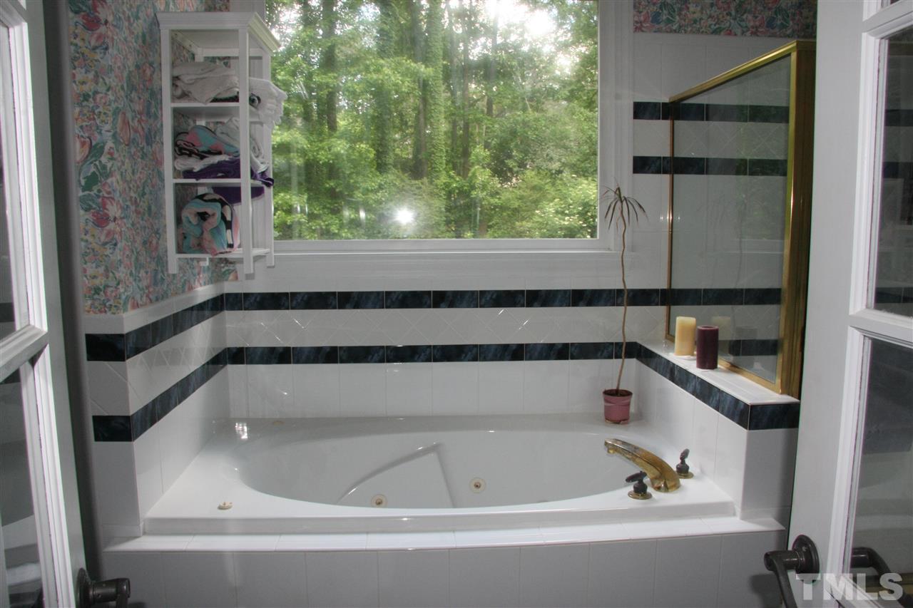 232 Release Circle Raleigh, NC 27615 - Photo 8 of 23 a bathroom with bathtub and window