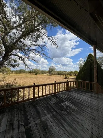 a view of a balcony with wooden floor and outdoor space