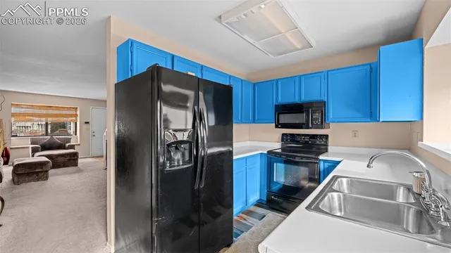 a kitchen with a refrigerator sink and microwave