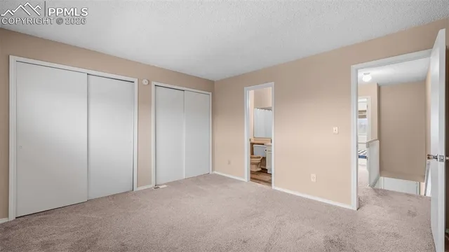 a view of an empty room and closet area