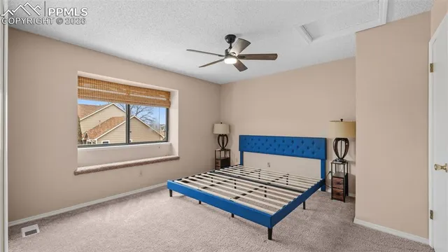 a bedroom with a bed and window