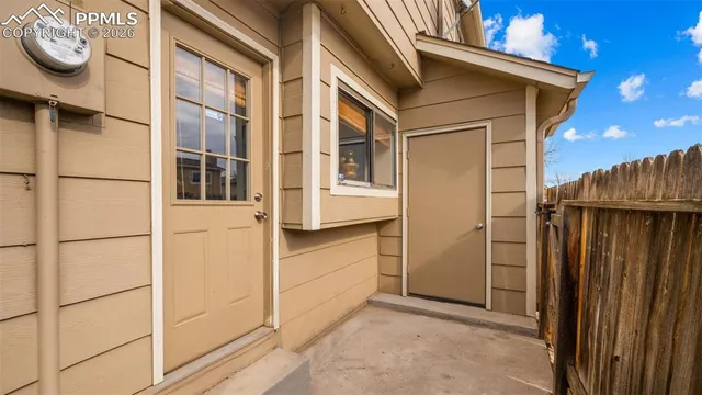a view of a house with a door and wooden walls