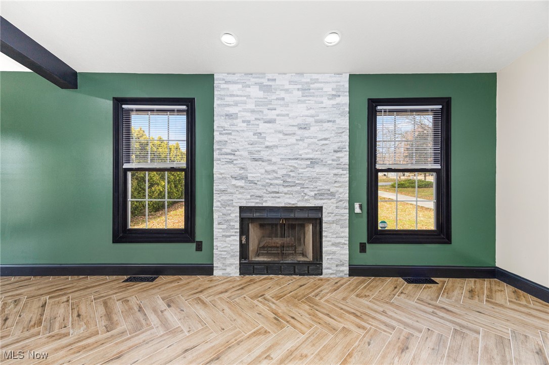 2840 Wadsworth Road Barberton, OH 44203 - Photo 6 of 32 Unfurnished living room with a fireplace and plenty of natural light