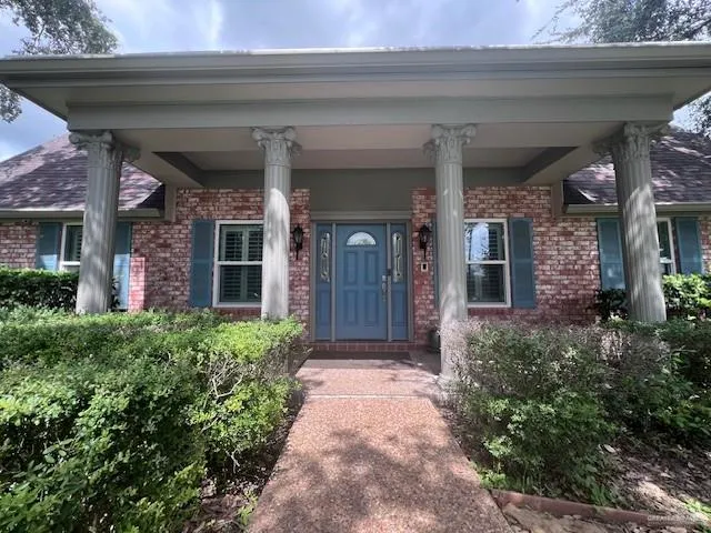 a view of a house with potted plants