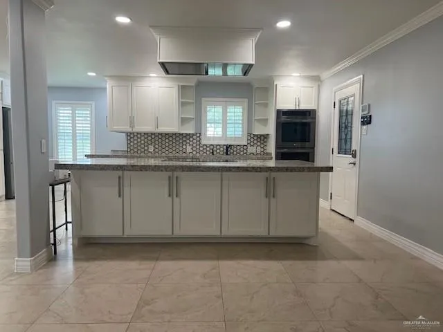 a kitchen with stainless steel appliances granite countertop a sink and a stove