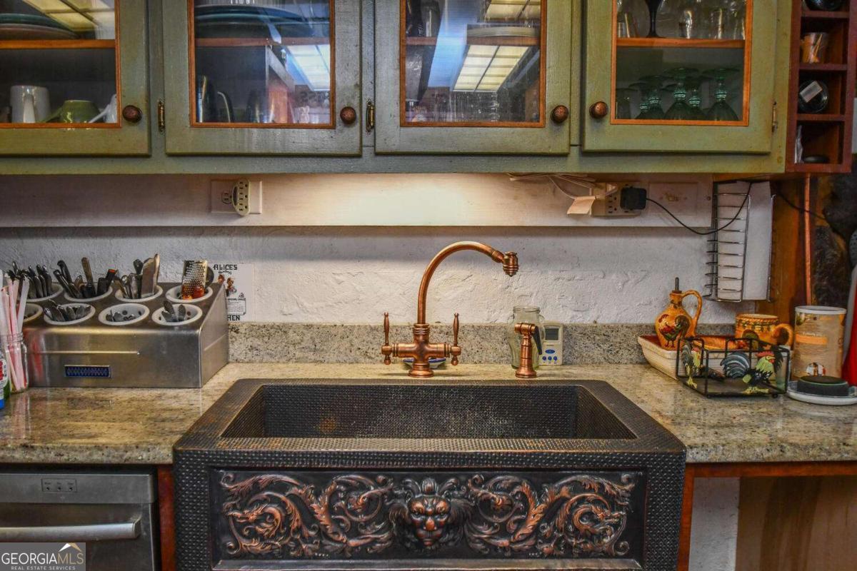 501 The Orchard Road Clarkesville, GA 30523 - Photo 7 of 20 a kitchen with a stove and a potted plant