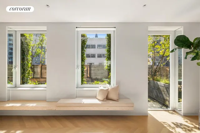 a bedroom with a large window with a bed